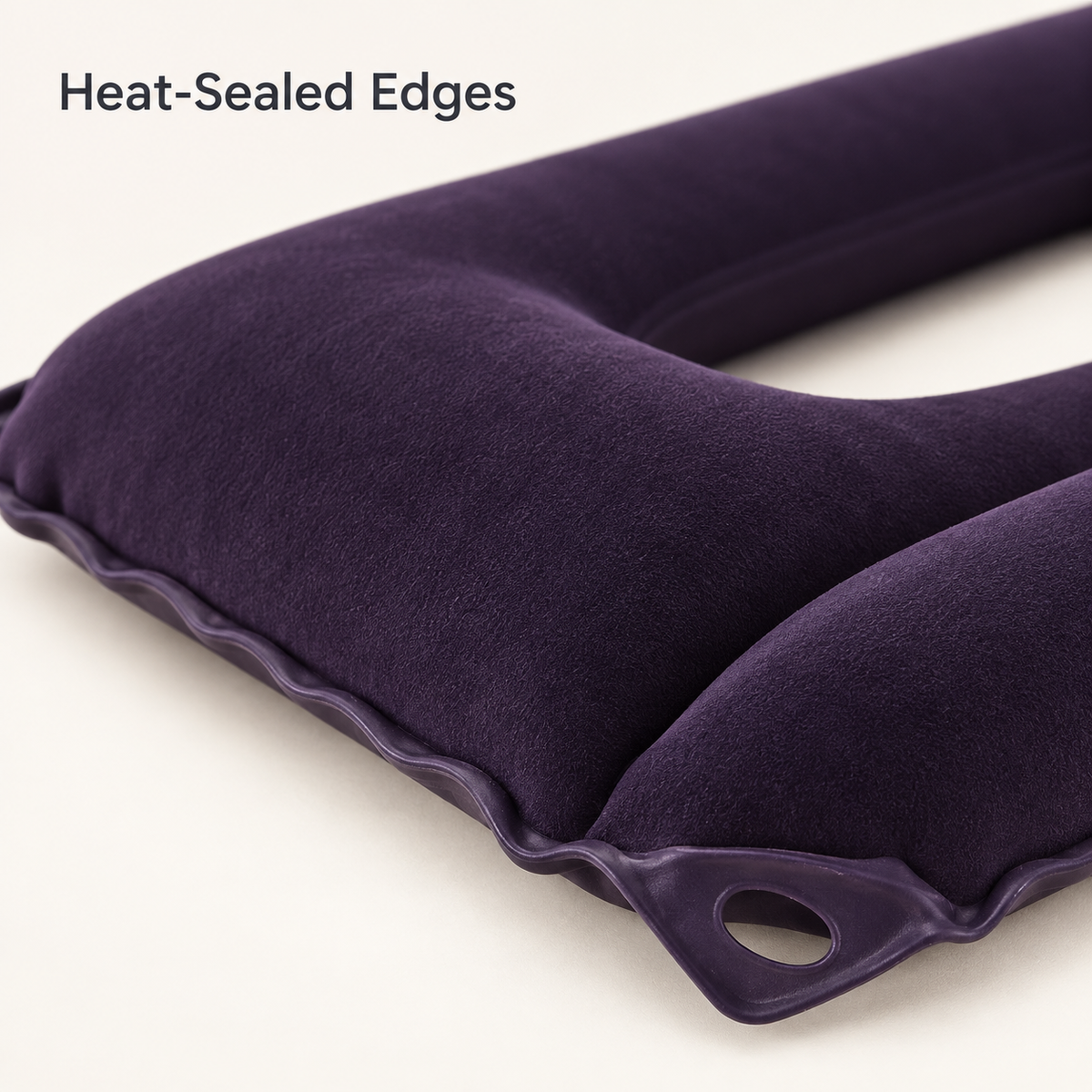 Close-up of the inflatable cushion's heat-sealed edge and corner eyelet.
