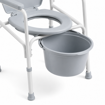 Close-up of the removable commode bucket under the seat opening