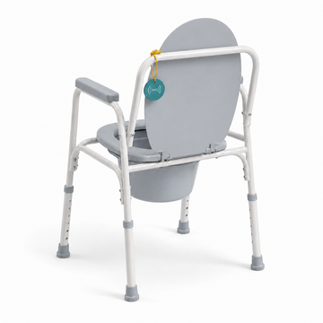 Rear angled view of the bedside commode chair showing the frame and adjustable legs