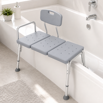 Bathtub transfer bench positioned across a bathtub edge in a bathroom
