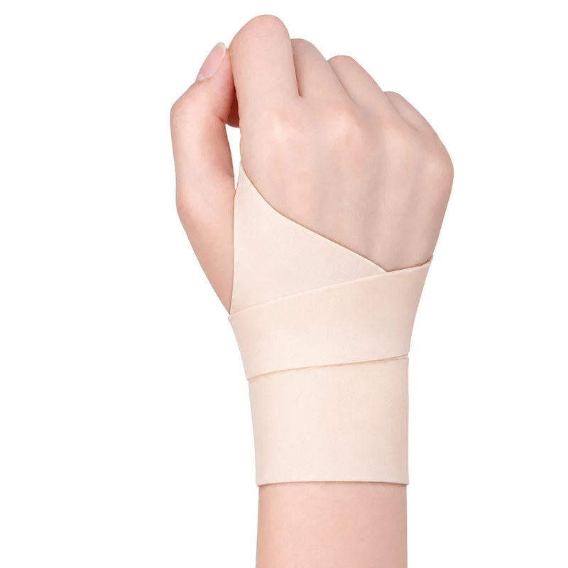 Close-up of a hand wearing the beige support wrap around the thumb and wrist on a white background.