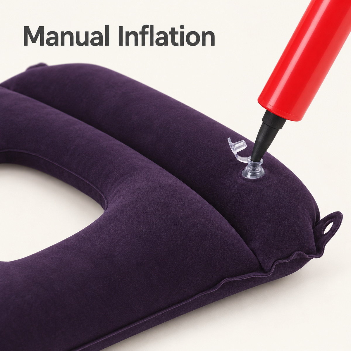 Red hand pump nozzle inserted into the clear air valve of the inflatable commode cushion.